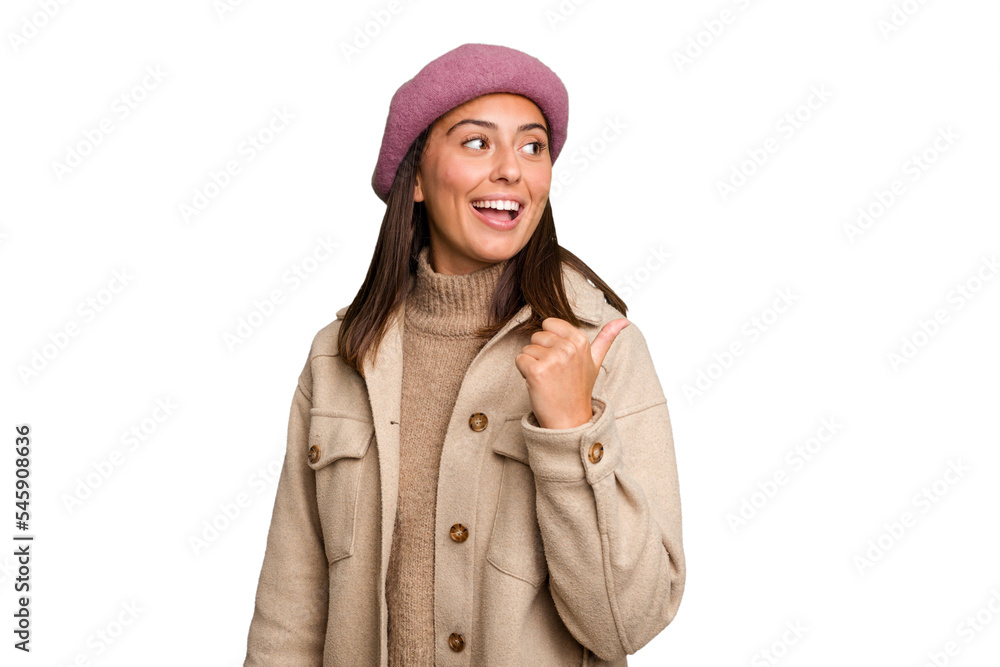 Young caucasian woman wearing winter jacket isolated points with thumb finger away, laughing and carefree. Young caucasian woman wearing winter jacket isolated points with thumb finger away, laughing and carefree.