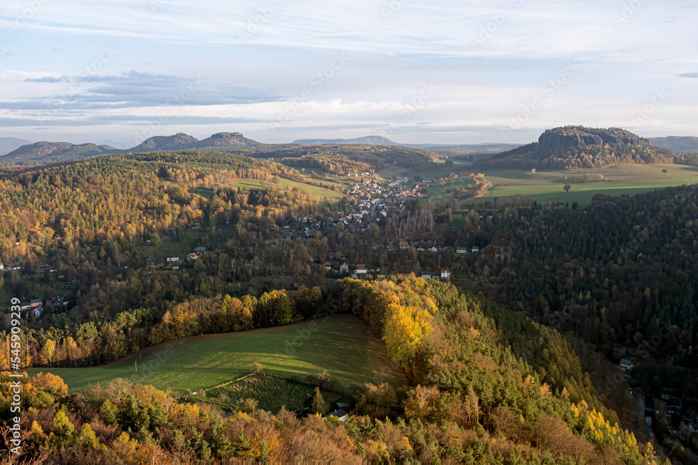 Panoramic view of Saxon Switzerland from the mountain on a warm autumn evening. Autumn evening and sunset give color to nature. High quality photo