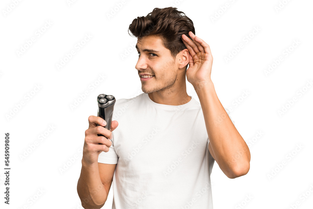 Young caucasian man holding a razor isolated trying to listening a gossip. Young caucasian man holding a razor isolated trying to listening a gossip.