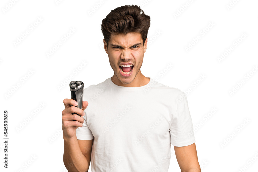 Young caucasian man holding a razor isolated screaming very angry and aggressive. Young caucasian man holding a razor isolated screaming very angry and aggressive.
