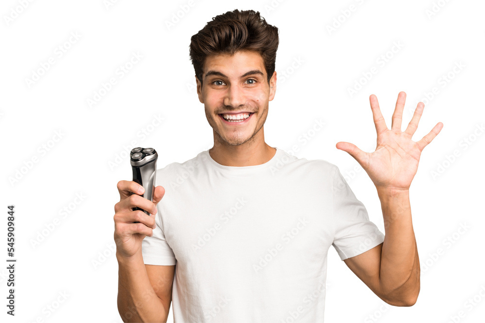 Young caucasian man holding a razor isolated smiling cheerful showing number five with fingers. Young caucasian man holding a razor isolated smiling cheerful showing number five with fingers.