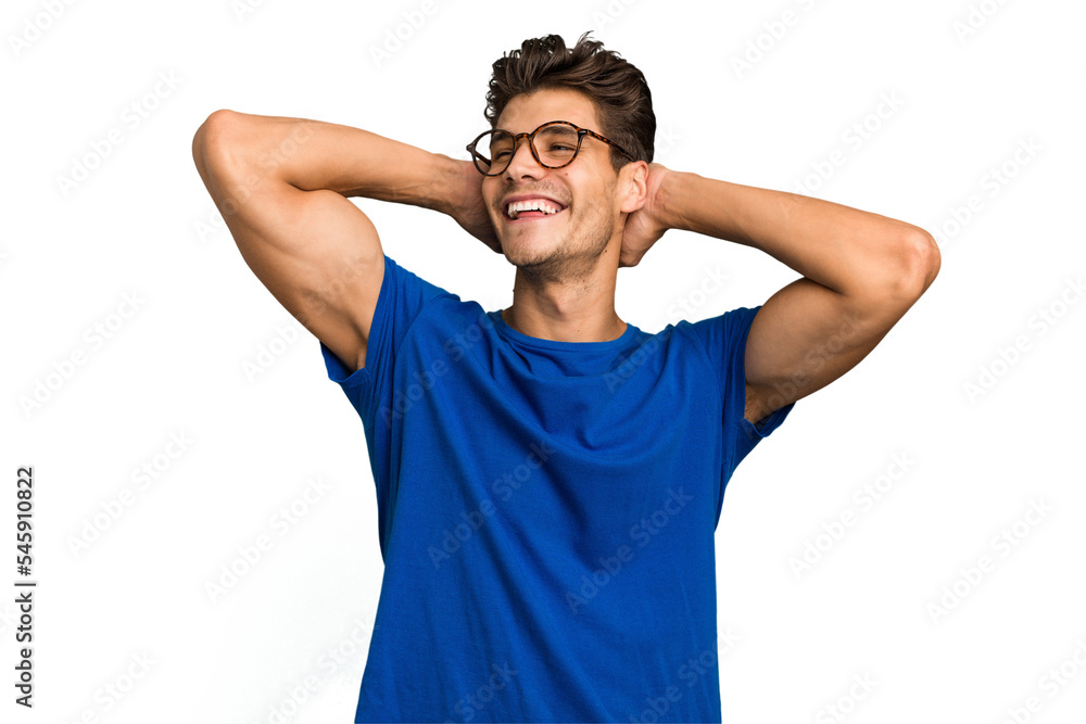 Young caucasian handsome man isolated feeling confident, with hands behind the head. Young caucasian handsome man isolated feeling confident, with hands behind the head.
