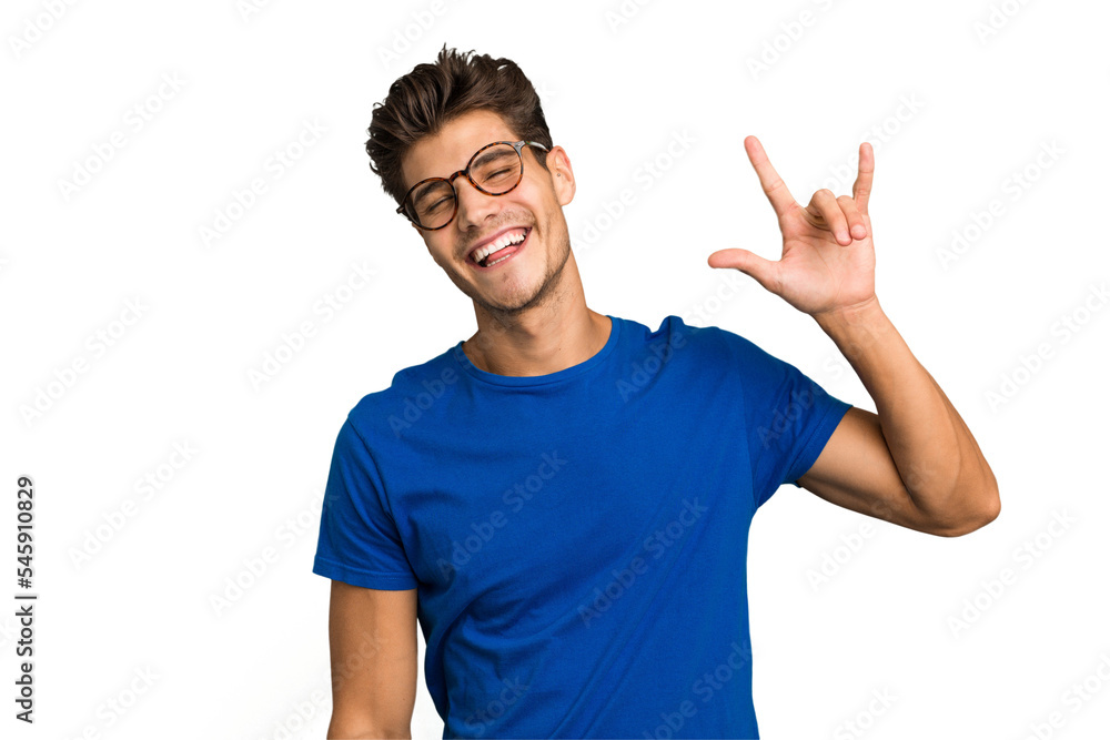 Young caucasian handsome man isolated showing a horns gesture as a revolution concept. Young caucasian handsome man isolated showing a horns gesture as a revolution concept.