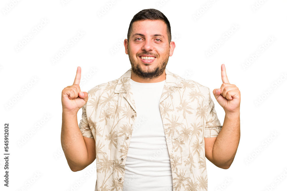 Young caucasian man isolated indicates with both fore fingers up showing a blank space. Young caucasian man isolated indicates with both fore fingers up showing a blank space.