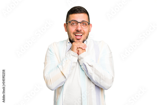 Young caucasian man isolated praying for luck, amazed and opening mouth looking to front.