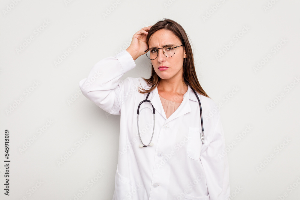 Fototapeta premium Young doctor woman isolated on white background being shocked, she has remembered important meeting.