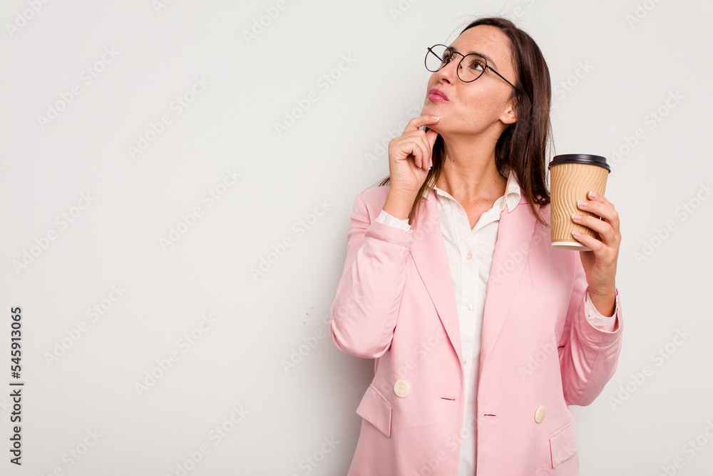 Business caucasian woman holding a take away coffee isolated on white background looking sideways with doubtful and skeptical expression. Business caucasian woman holding a take away coffee isolated on white background looking sideways with doubtful and skeptical expression.