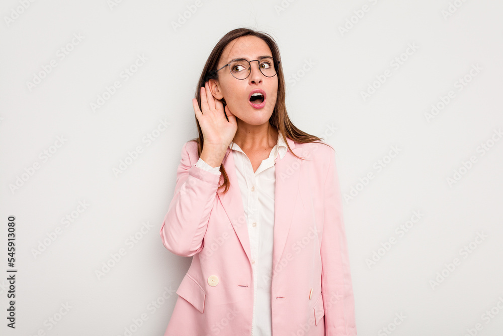 Business caucasian woman isolated on white background trying to listening a gossip. Business caucasian woman isolated on white background trying to listening a gossip.
