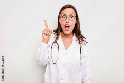 Young doctor woman isolated on white background having an idea, inspiration concept.