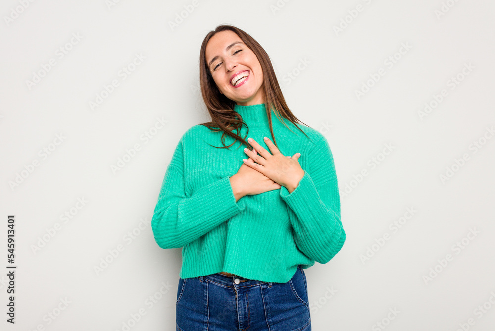Young caucasian cute woman isolated on white background has friendly expression, pressing palm to chest. Love concept. Young caucasian cute woman isolated on white background has friendly expression, pressing palm to chest. Love concept.