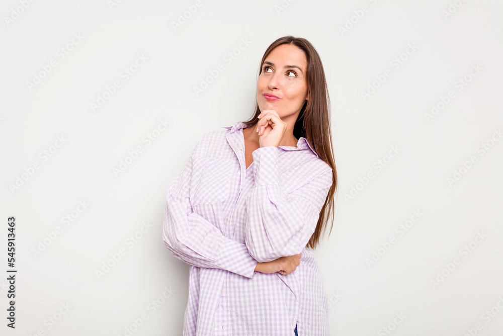 Young caucasian cute woman isolated on white background thinking and looking up, being reflective, contemplating, having a fantasy.