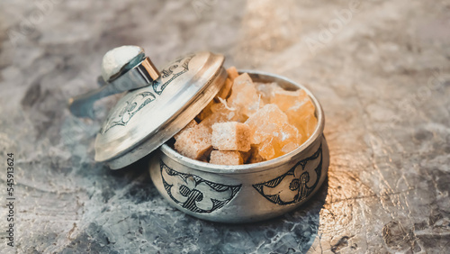 Cubes of sugar and Turkish sweets in authentic bowl 