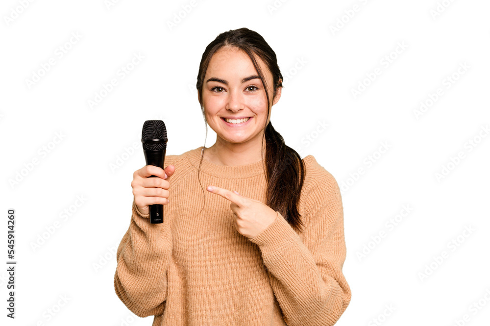 Young caucasian singer woman isolated on green chroma background smiling and pointing aside, showing something at blank space. Young caucasian singer woman isolated on green chroma background smiling and pointing aside, showing something at blank space.