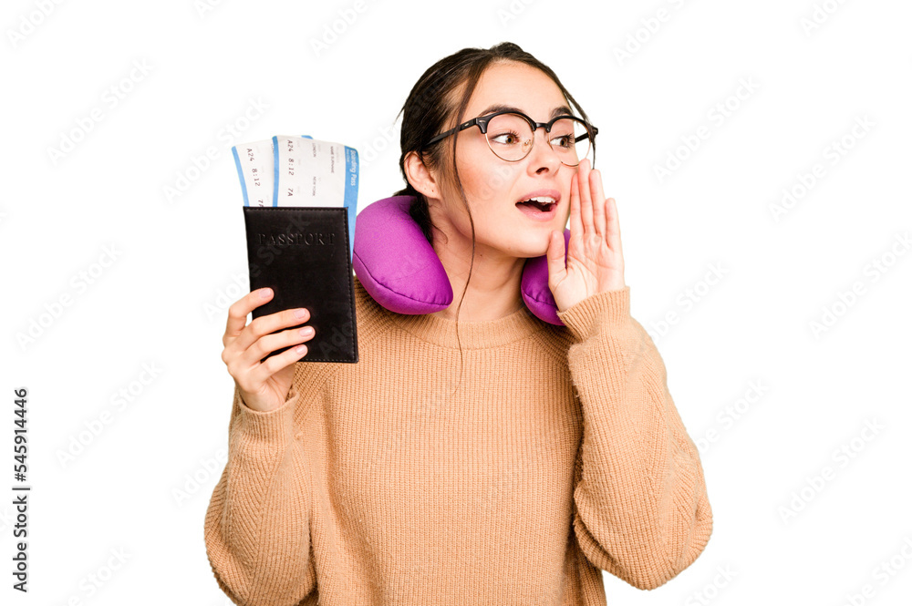 Young caucasian woman with inflatable travel pillow holding passport isolated on green chroma background shouting and holding palm near opened mouth. Young caucasian woman with inflatable travel pillow holding passport isolated on green chroma background shouting and holding palm near opened mouth.