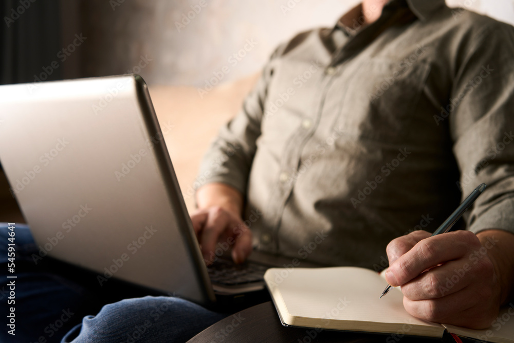 Man using on notebook and working on laptop computer Man using on notebook and working on laptop computer