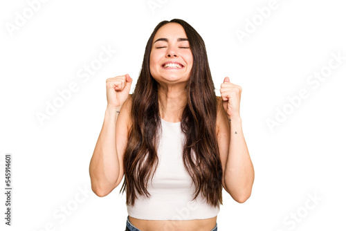 Young caucasian woman isolated on green chroma background celebrating a victory, passion and enthusiasm, happy expression.