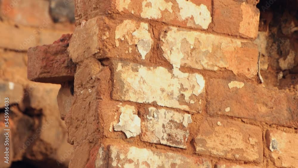 Close-up of a destroyed red brick wall, the remains of a burnt house. An abandoned building, a consequence of the war, bombing, missile strikes. Ruins, people in evacuation. UHD 4K. Close-up of a destroyed red brick wall, the remains of a burnt house. An abandoned building, a consequence of the war, bombing, missile strikes. Ruins, people in evacuation. UHD 4K.