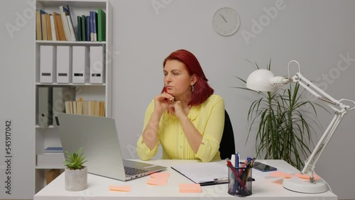 Thoughtful woman working on laptop computer looking away thinking solving problem at home office, serious woman search for inspiration make decision feel lack of ideas, close up view photo