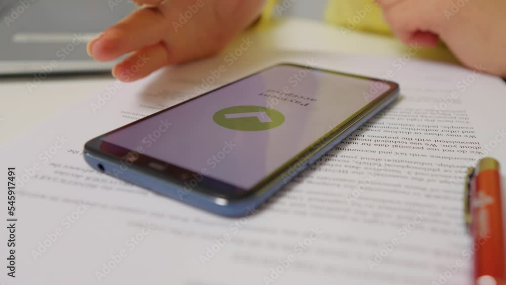 Close-up hand and phone successfully paying online purchase. Nervous tapping waiting for online pay confirmation. Close-up hand and phone successfully paying online purchase. Nervous tapping waiting for online pay confirmation.