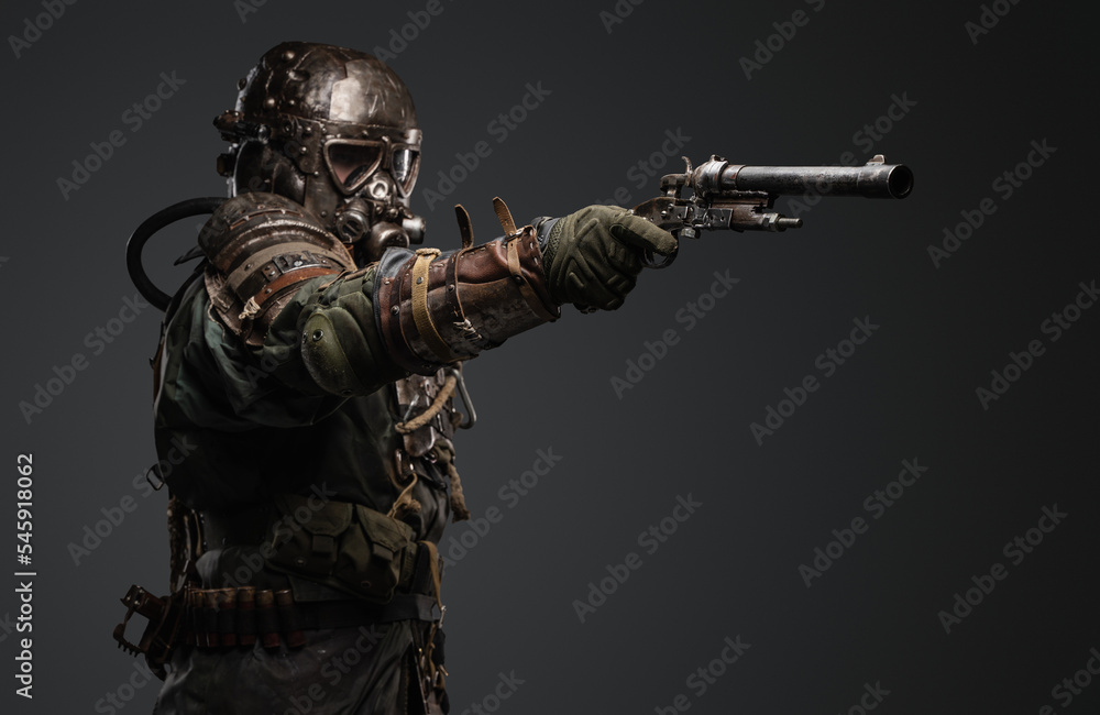 Shot of isolated on grey background soldier in setting of post apocalypse aiming pistol. Shot of isolated on grey background soldier in setting of post apocalypse aiming pistol.