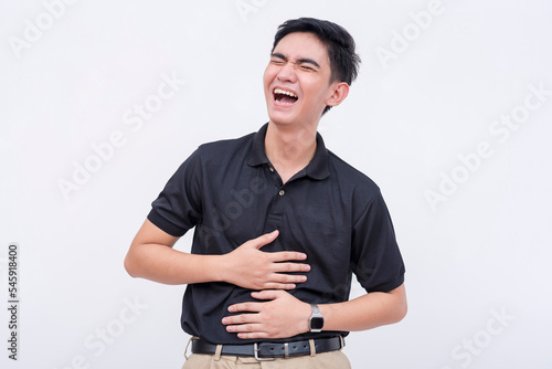 A young man bursting into a fit of laughter. A asian person having fun. Laughing so hard his stomach hurts. isolated on a white background. photo