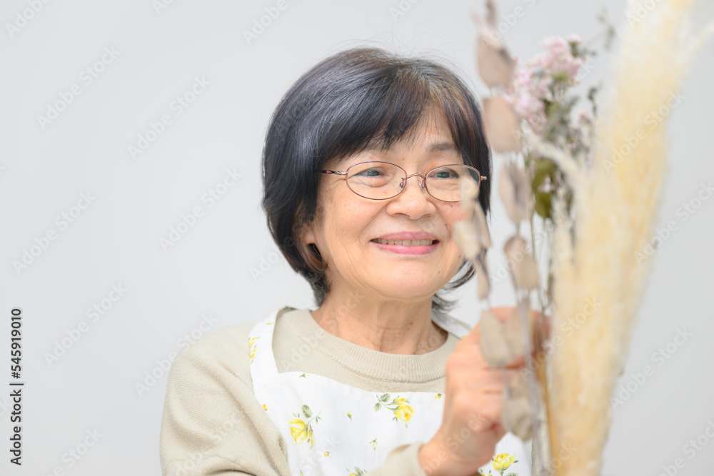 Lovely Asian grandmother whose hobby is flowers. Lovely Asian grandmother whose hobby is flowers.
