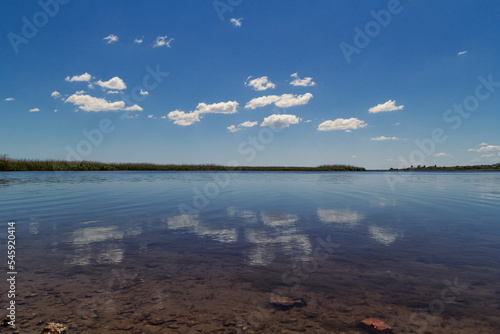 Clouds reflection in lake landscape photo. Beautiful nature scenery photography with lakeshore on background. Idyllic scene. High quality picture for wallpaper  travel blog  magazine  article