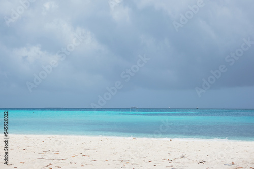 Beautiful beach of Fulidhoo, Maldives during raining season, with gloomy weather. © peacefoo
