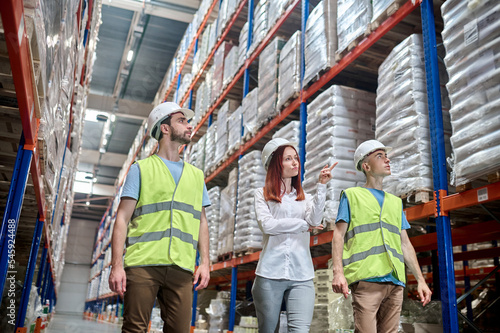 Team of warehouse employees conducting a racking system inspection