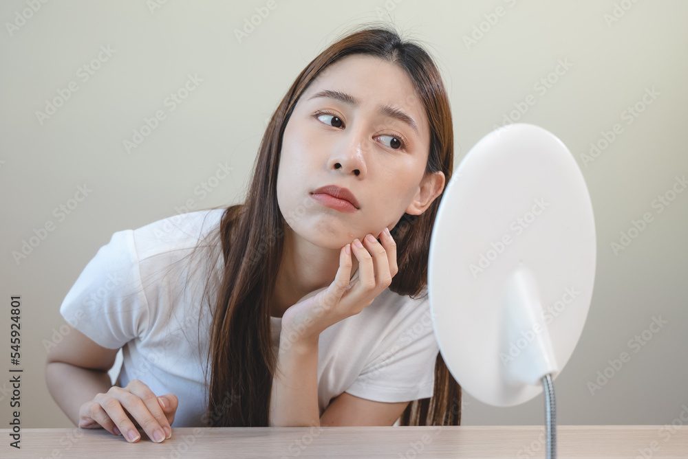 skin problem treatment. Women looking acne on her face in the mirror. skin problem treatment. Women looking acne on her face in the mirror.