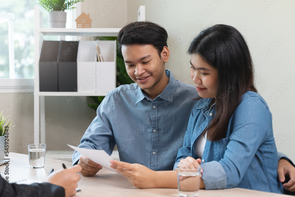 Asian couple meeting real estate agent consulting to mortgage house Asian couple meeting real estate agent consulting to mortgage house