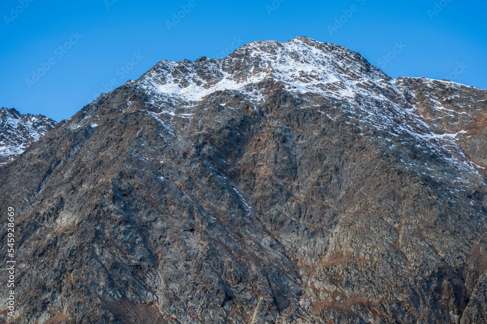 Peak and ridge of high rocky mountains with cliffs.