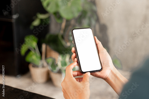 cell phone blank white screen mockup.hand holding texting using mobile on desk at office.background empty space for advertise.work people contact marketing business,technology