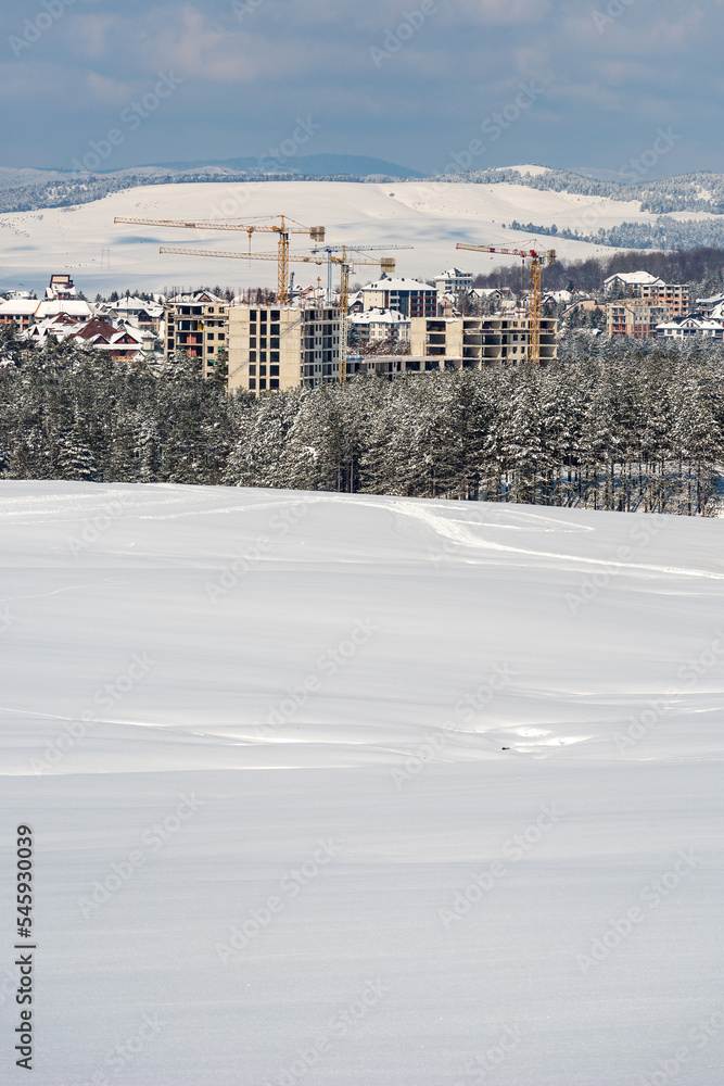 Construction industry apartment and housing development at Zlatibor in winter season under snow