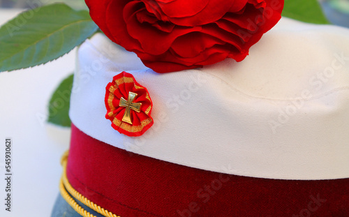 Danish traditional student cap and a red rose for students who have graduated from high school