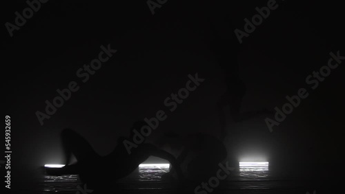Wallpaper Mural Modern ballet dancers performing together on dark stage. Silhouettes of three performers with smoke in the air. Torontodigital.ca