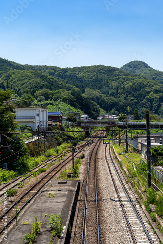 railroad tracks run through the countryside in Yamanashi prefecture, Japan.