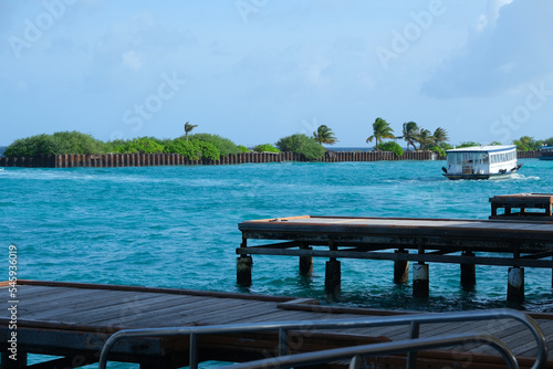 The harbour at Male International Airport Maldives with ferry crossing around.