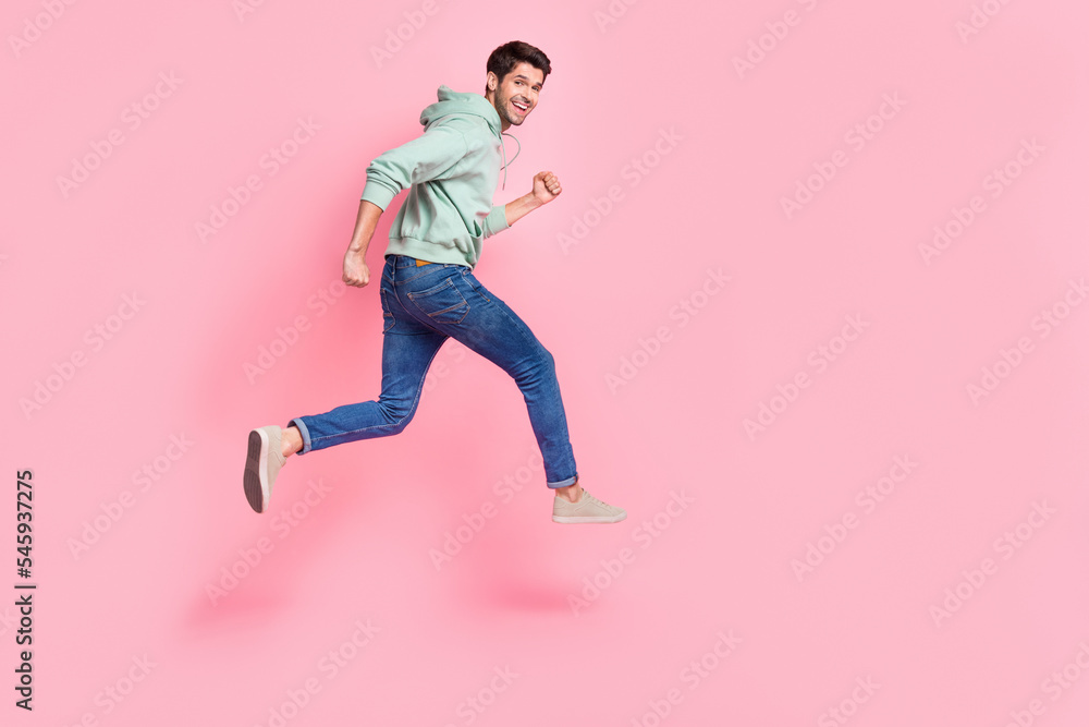 Full length profile side photo of joyful satisfied boy trendy clothes go empty space sports competitions isolated on pink color background Full length profile side photo of joyful satisfied boy trendy clothes go empty space sports competitions isolated on pink color background