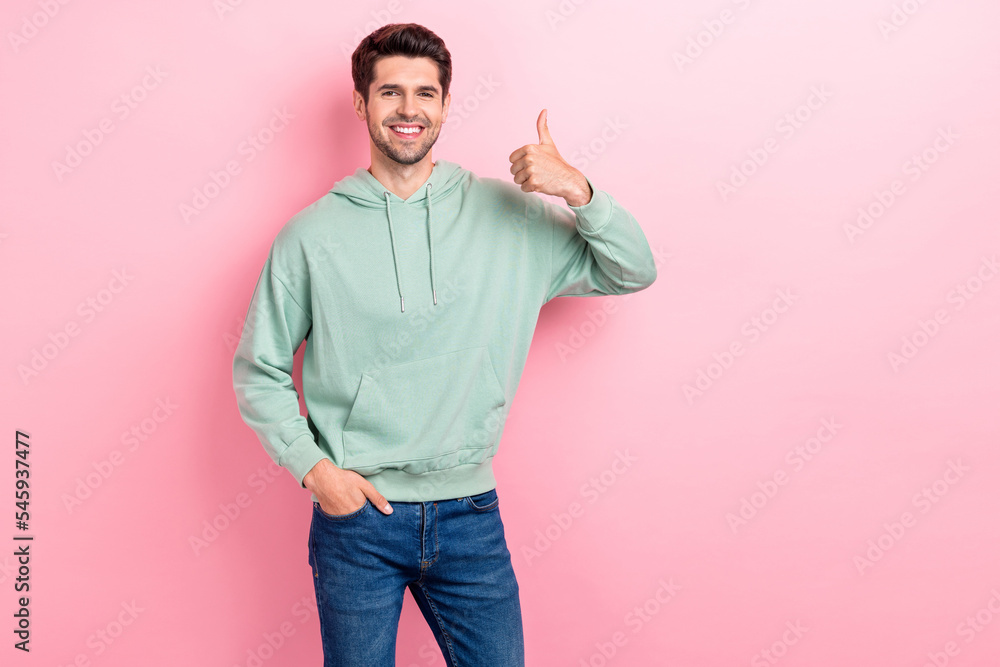 Photo of youngster positive cheerful man toothy smiling showing thumb up like recommend new offer empty space brand clothes isolated on pink color background Photo of youngster positive cheerful man toothy smiling showing thumb up like recommend new offer empty space brand clothes isolated on pink color background