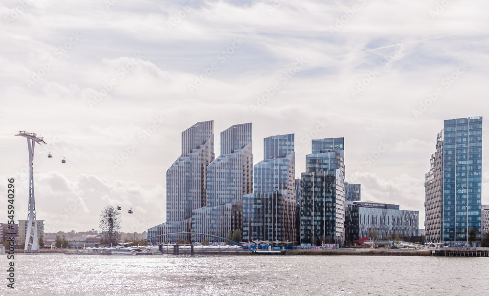 Fototapeta premium upper riverside modern apartment building complex with balconies and architectural structure, greenwich peninsula in london, united kingdom, october 22, 2022