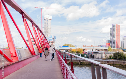 public single span pedestrians foot bridge over river lea links east london city Island apartment housing and offices to canning town dlr station, october 22, 2022 in london, united kingdom photo