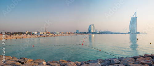 Obraz na plátně DUBAI, UAE - MARCH 30, 2017: The evening skyline with the Burj al Arab and Jumeirah Beach Hotels and the open Jumeriah beach