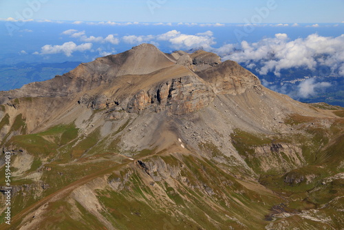 Close-up view of the landscape with mountain peak in the foreground against a blue sky with clouds on Mount Schilthorn, near Lauterbrunnen and Interlaken in Switzerland