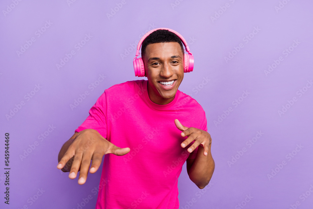 Closeup photo of young excited dancing hipster guy neon wireless earphones new shopping sale dancing nice stereo isolated on purple color background Closeup photo of young excited dancing hipster guy neon wireless earphones new shopping sale dancing nice stereo isolated on purple color background