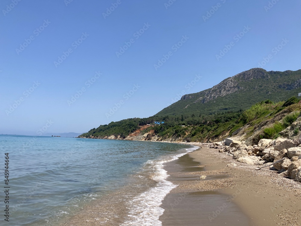Rocky Prasoudi beach in Corfu island, Greece, in summer time