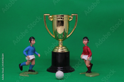Football Soccer figures and cup , gold trophy ,  football players in red and blue  with  football, vintage toys from 1970s -1980s, Soccer action figures. 