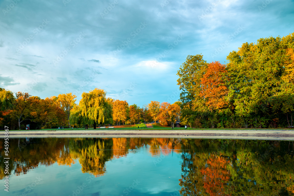 Beautiful autumn landscape, trees in the morning light are reflected in the lake Beautiful autumn landscape, trees in the morning light are reflected in the lake