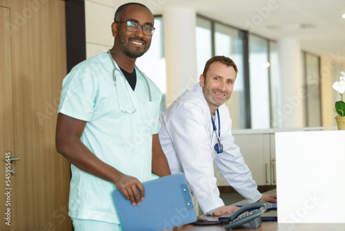 young practitioner doctor working at the clinic reception desk photo