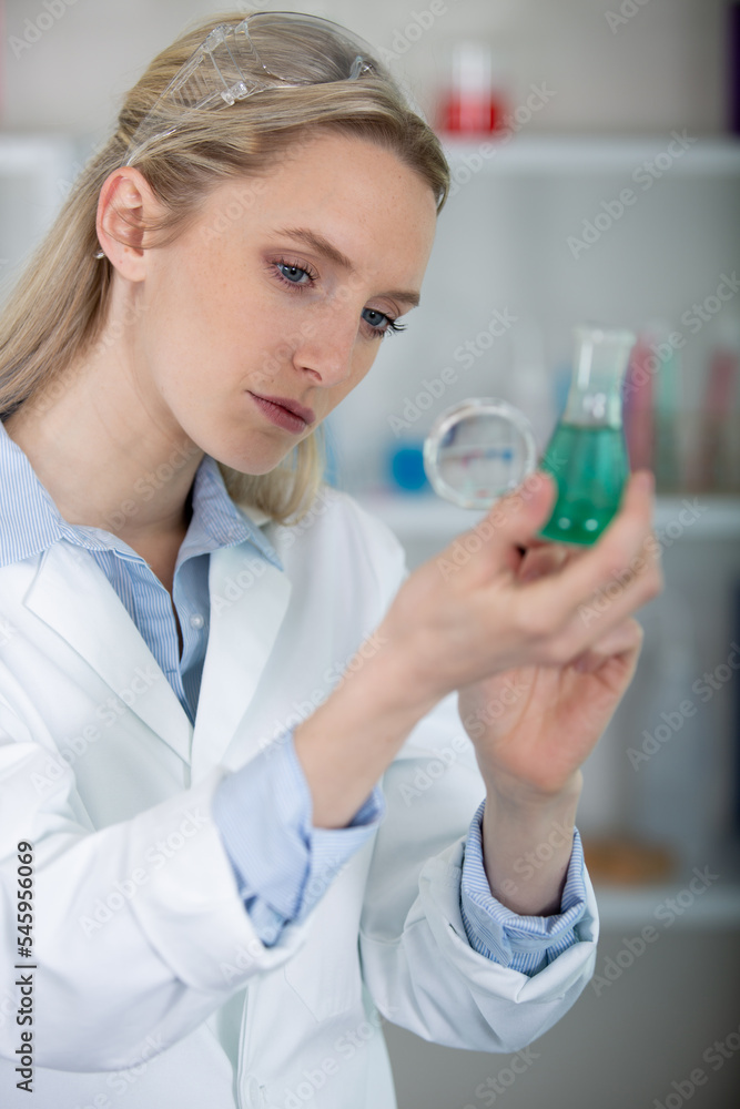 female research scientist filling test tubes